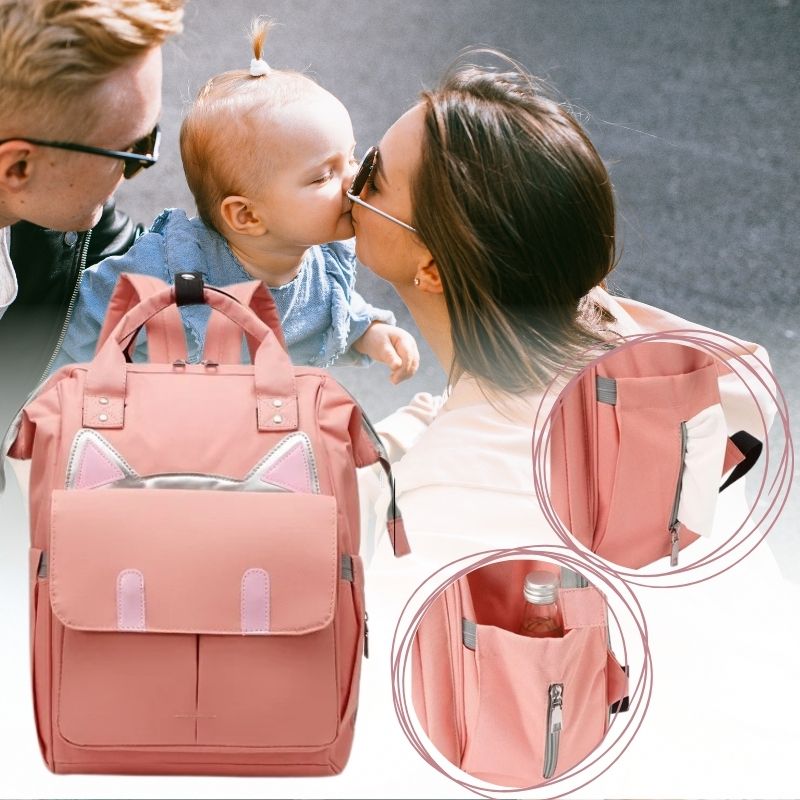 sac à langer à dos rose avec des poches extérieures