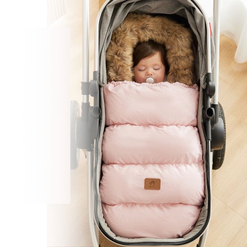 bébé dort dans chancelière rose douillet