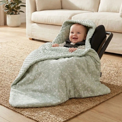 NID D'ANGE 0-6 MOIS vert plante posé sur une table ou un parc, maman tient bébé dans ses bras