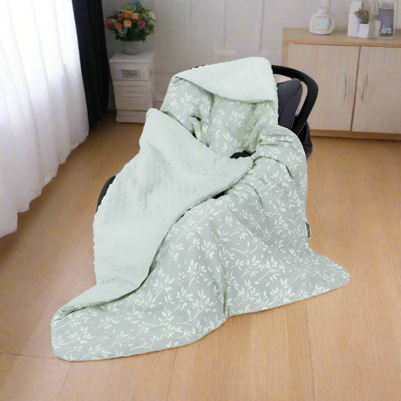 nid d'ange cosy vert installé dans siège auto