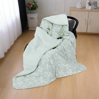 nid d'ange cosy vert installé dans siège auto